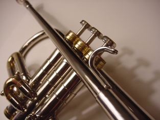 Featured is a macro photo of the valves of a trumpet ... a member of the brass musical instrument family.  Photo by US photographer Pam Roth.